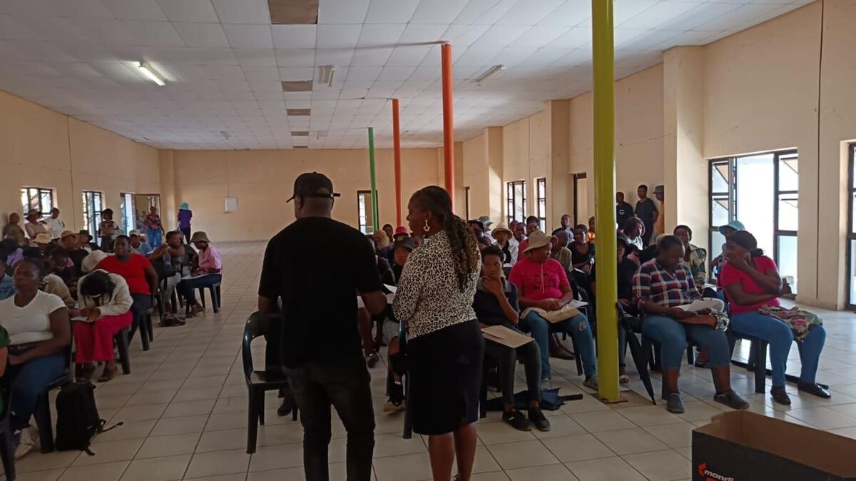 A packed community hall in Limpopo full of selected learners seated for a Kaylord cohort induction, with Kaylord staff at the front.
